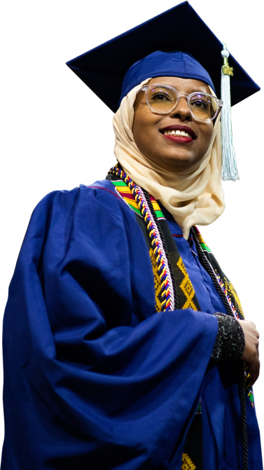 Graduating woman in full robe and cap with a hijab