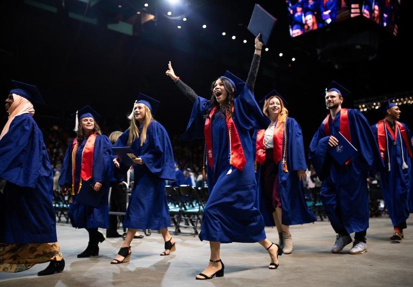 Collection of graduating MSU Denver students with the center woman celebrating