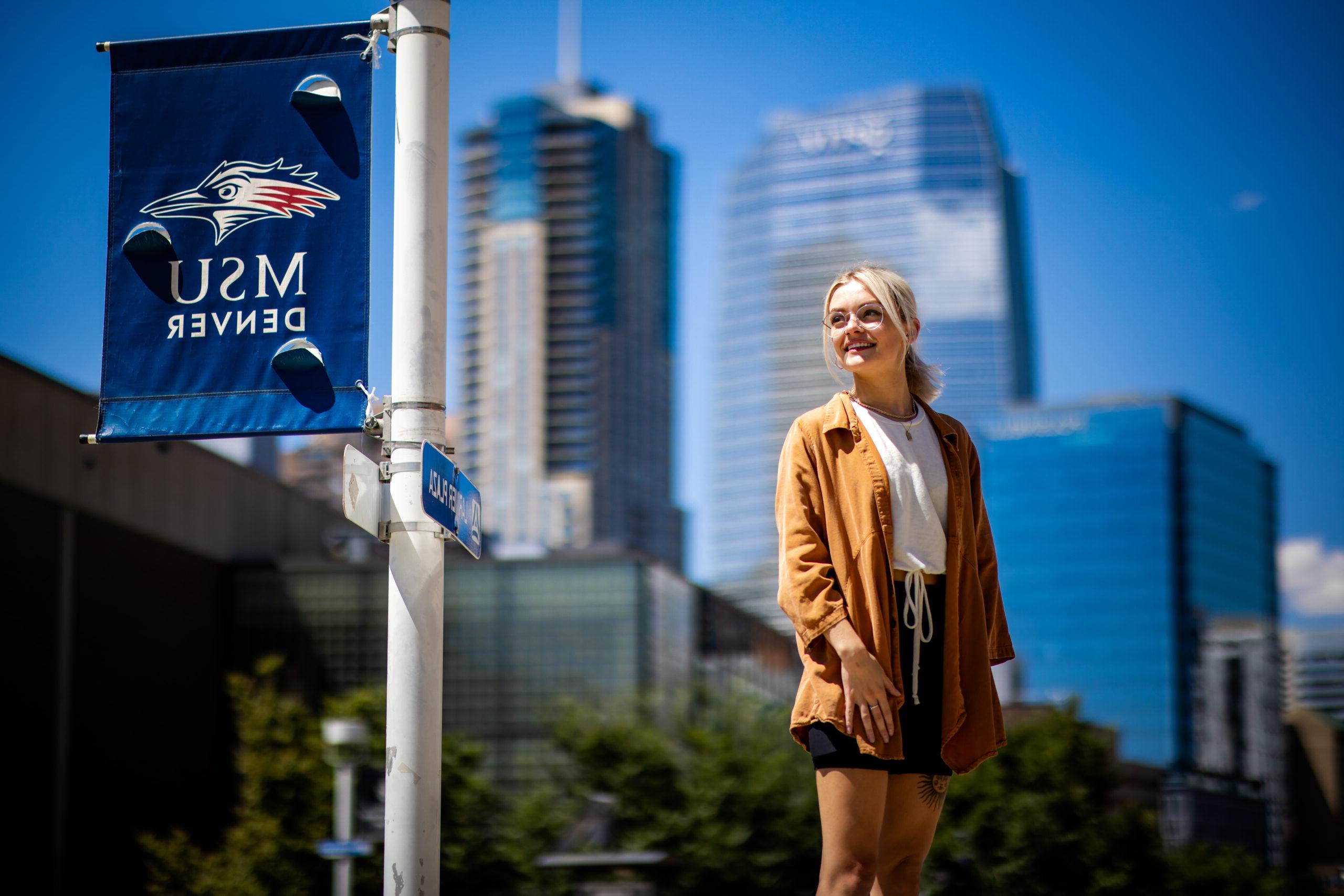 Student stands on campus.